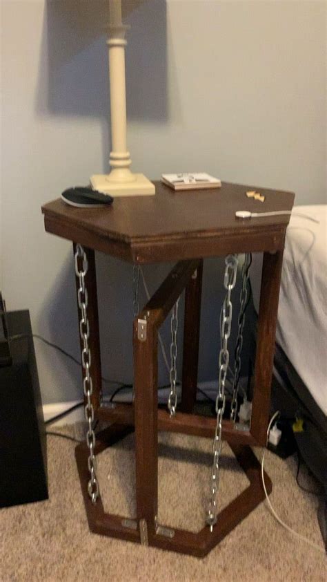 Normally the top table would just fall to either side, but the corner chains prevent that. . Floating chain table